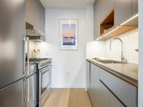 Bronx apartment for rent - a kitchen with stainless steel appliances and a painting on the wall
