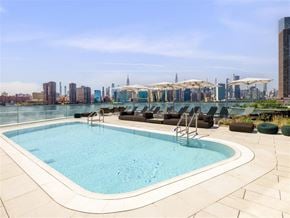 Brooklyn apartment for rent - a pool on the roof of a building with a city in the background