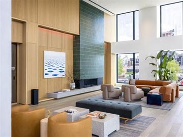Brooklyn apartment for rent - A modern living room with a large painting and a fireplace.