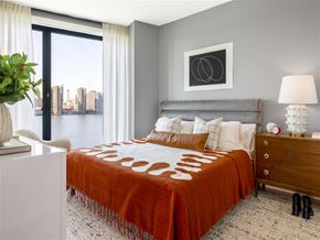 Brooklyn apartment for rent - a bedroom with a bed and a city view