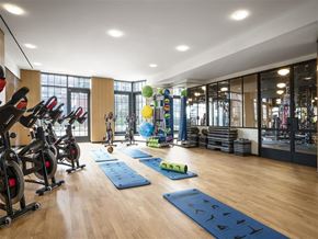 Brooklyn apartment for rent - a gym with exercise equipment and yoga mats on the floor