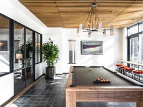 Brooklyn apartment for rent - a pool table in a living room with a painting on the wall