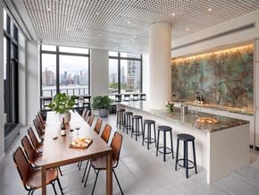 Brooklyn apartment for rent - A modern dining room with a long table set for a meal.
