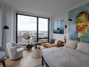 Brooklyn apartment for rent - a bedroom with a bed and a couch and a window