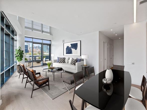 Brooklyn apartment for rent - a living room with a black table and a white couch