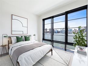 Brooklyn apartment for rent - a bedroom with a bed and a view of a river