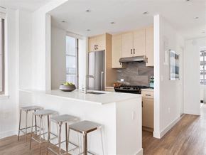 New York apartment for rent - a kitchen with a large island and three bar stools