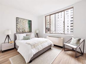 New York apartment for rent - a bedroom with a bed and a large window