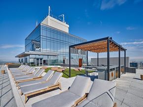 New York apartment for rent - a row of lounge chairs on top of a building
