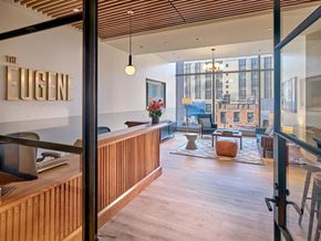 New York apartment for rent - The interior of a modern office space with wooden floors and furniture.