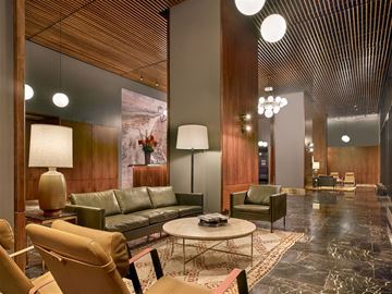 New York apartment for rent - A modern living room with a green sofa and a wooden ceiling.