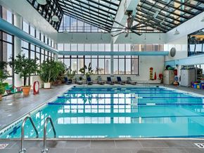New York apartment for rent - a large swimming pool in a building with large windows