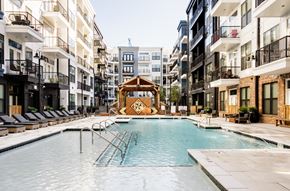 Nashville apartment for rent - A swimming pool in the middle of a courtyard surrounded by buildings.