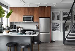 Arlington apartment for rent - A modern kitchen with a stainless steel refrigerator and black bar stools.