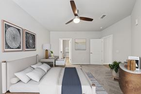Woodstock apartment for rent - A bedroom with a bed, a ceiling fan, and a nightstand with a lamp.