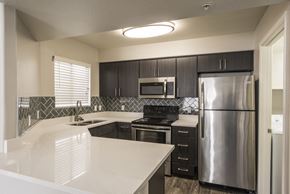 Phoenix apartment for rent - a kitchen with stainless steel appliances and white counter tops