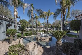 Phoenix apartment for rent - a fountain in a courtyard with palm trees