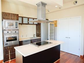 Dallas apartment for rent - a kitchen with a white counter top and a stainless steel stove