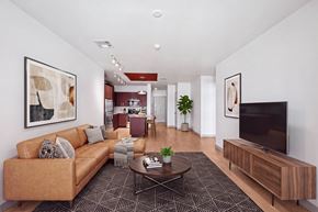 Dallas apartment for rent - A living room with a brown couch and a coffee table.