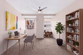 Dallas apartment for rent - A room with a desk, chair, and bookshelf.