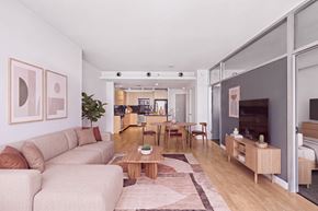 Dallas apartment for rent - A living room with a couch, coffee table, and a dining table.