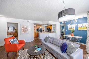 Las Vegas apartment for rent - A living room with a grey couch and a red chair.