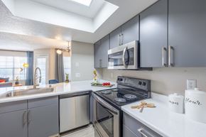 Las Vegas apartment for rent - Apartment open concept kitchen with stainless steel appliances and white countertops and grey cabinetry.
