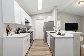 West Palm Beach apartment for rent - A modern kitchen with white cabinets and appliances.