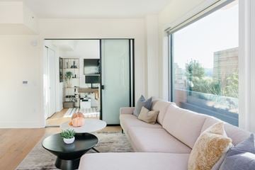 San Francisco apartment for rent - A modern living room with a white sofa and a black coffee table.
