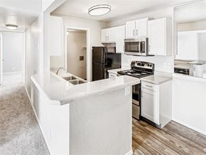 Murray apartment for rent - a large kitchen with white cabinets and stainless steel appliances