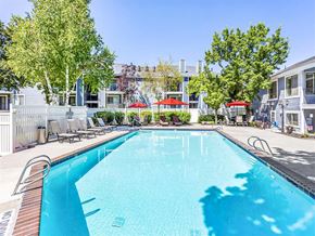 Murray apartment for rent - a swimming pool with trees and apartments in the background
