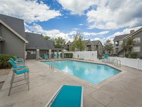 Murray apartment for rent - a swimming pool with chairs around it and apartments in the background