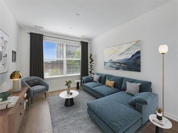 Alexandria apartment for rent - A living room with a grey couch and a painting on the wall.