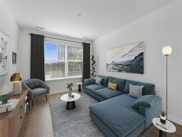 Alexandria apartment for rent - a living room with blue furniture and a large window