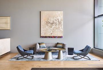 Jersey City apartment for rent - A living room with a large abstract painting on the wall and a coffee table in the center.