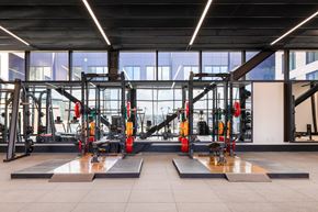 Washington apartment for rent - A gym with a variety of equipment including a squat rack and bench press.