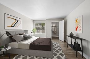 Las Vegas apartment for rent - A bedroom with a large bed and a painting on the wall.