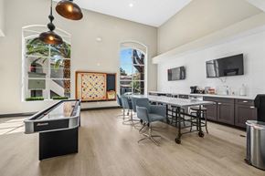 Las Vegas apartment for rent - A room with a pool table and a kitchen area.