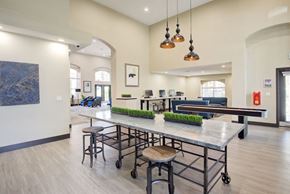 Las Vegas apartment for rent - a communal area with a ping pong table and chairs