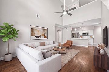 Houston apartment for rent - A living room with a white couch and a wooden floor.
