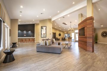 Las Vegas apartment for rent - A living room with a grey couch and a wooden fireplace.
