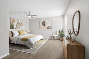 Las Vegas apartment for rent - A bedroom with a bed, chair, and artwork on the wall.
