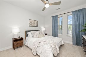 Charlotte apartment for rent - a bedroom with a bed and a ceiling fan