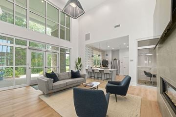 Charlotte apartment for rent - A modern living room with a grey sofa and a grey armchair.