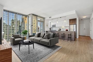 Chicago apartment for rent - A modern living room with a grey sofa and a black coffee table.