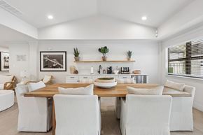 Tampa apartment for rent - A dining room with a wooden table and white chairs.