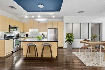 Dallas apartment for rent - A kitchen with wooden floors and a blue ceiling.