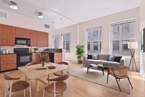 Los Angeles apartment for rent - A modern kitchen with wooden cabinets and a dining table with chairs.