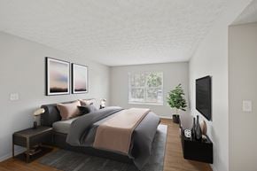 Columbus apartment for rent - A bedroom with a large bed and a flat screen TV mounted on the wall.