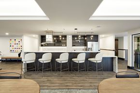 Oakland apartment for rent - A modern kitchen with white chairs and a wooden table.